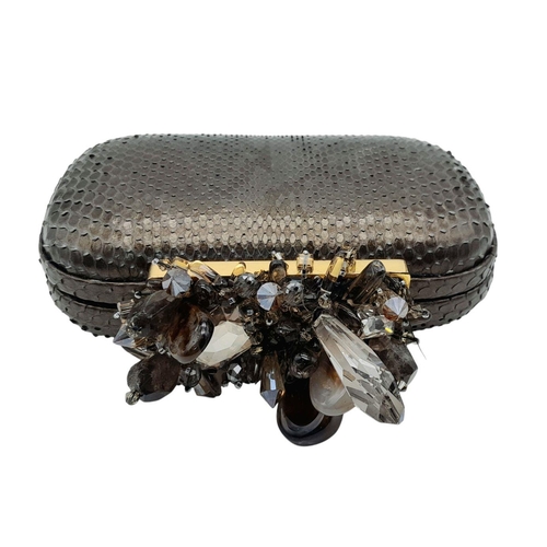 179 - A Madiso Brown Clutch Bag. Python skin exterior with stone embellish clasp fastening closure. Silver... 