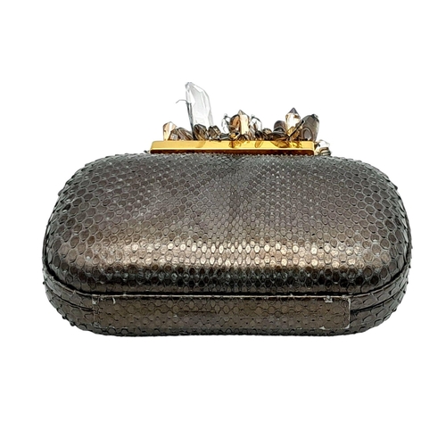 179 - A Madiso Brown Clutch Bag. Python skin exterior with stone embellish clasp fastening closure. Silver... 