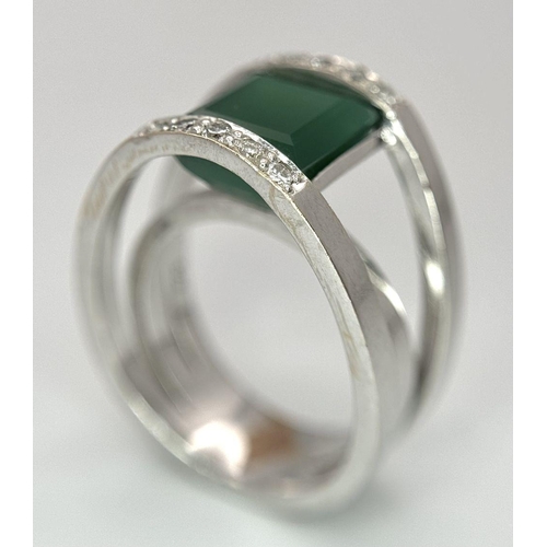 18 - A 21k White Gold, Emerald and Diamond Orbital Ring. A large 3ct square cut central emerald with diam... 