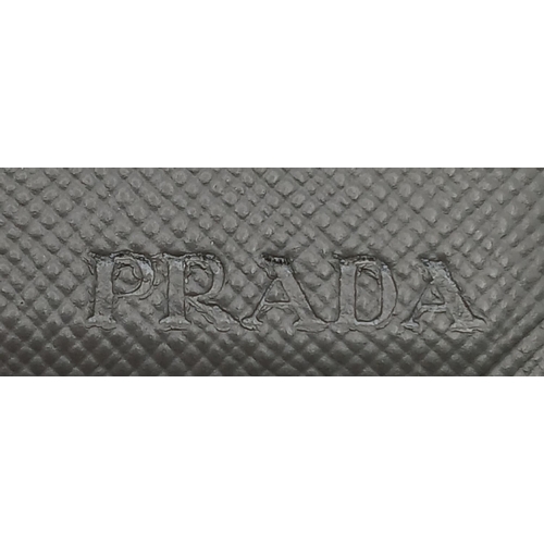 193 - A Prada Grey Saffiano Leather Card Holder. Grey Saffiano leather exterior. Grey leather interior wit... 