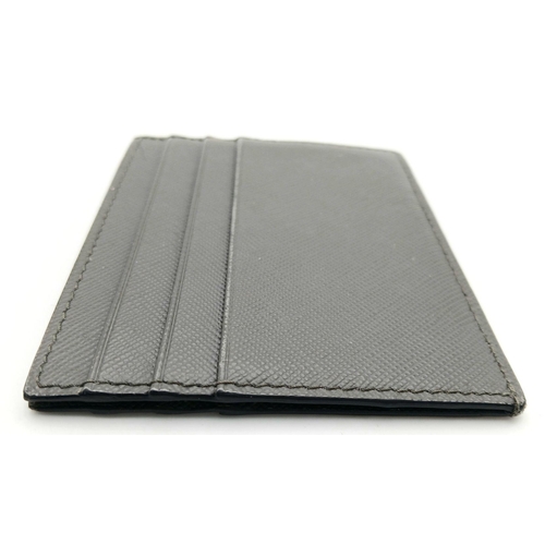 193 - A Prada Grey Saffiano Leather Card Holder. Grey Saffiano leather exterior. Grey leather interior wit... 