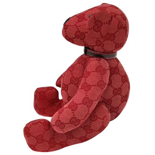 200 - A Gucci Red Teddy Bear Plush Toy. Monogram canvas exterior. Approximately 26cm length. Fixable damag... 