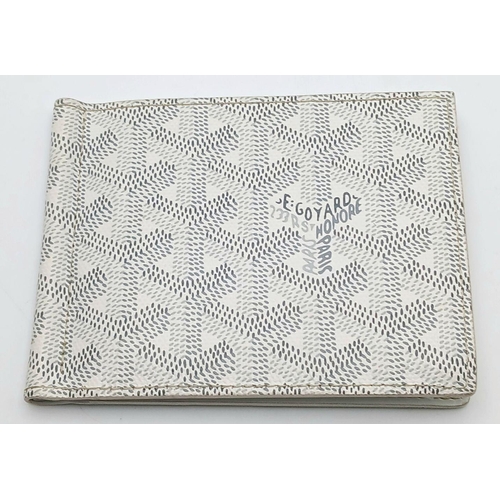 221 - A Goyard Victoire White Wallet. White canvas exterior with Goyardine monogram pattern and silver-ton... 