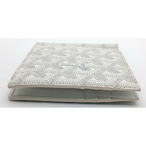 221 - A Goyard Victoire White Wallet. White canvas exterior with Goyardine monogram pattern and silver-ton... 