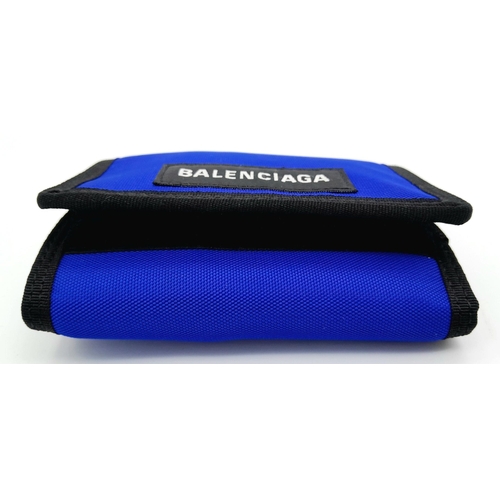 242 - A Balenciaga Nylon Trifold Wallet. Blue and black textile exterior with a velcro closure. Black text... 