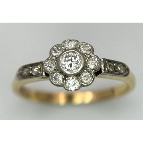 25 - An 18K Yellow Gold, Platinum and Diamond Ring. 0.75ctw of diamonds in floral form. Size Q 1/2. 3.5g ... 