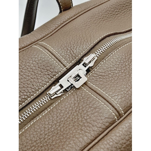 60 - A Hermes Taurillon Clemence Victoria II 35 Handbag. Etoupe leather exterior with silver toned hardwa... 