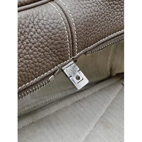 60 - A Hermes Taurillon Clemence Victoria II 35 Handbag. Etoupe leather exterior with silver toned hardwa... 