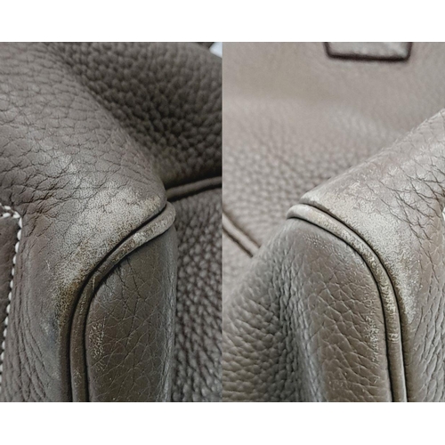 60 - A Hermes Taurillon Clemence Victoria II 35 Handbag. Etoupe leather exterior with silver toned hardwa... 