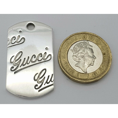 695 - A Gucci Sterling Silver Pendant. 3.5cm. 12g.