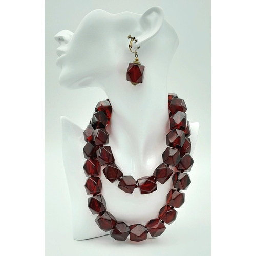 1571 - A matching set of faceted cherry-coloured resin necklace and earrings. Necklace approx 93cm in lengt... 