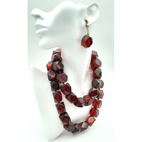 1571 - A matching set of faceted cherry-coloured resin necklace and earrings. Necklace approx 93cm in lengt... 