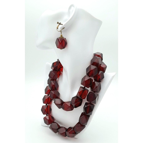 1571 - A matching set of faceted cherry-coloured resin necklace and earrings. Necklace approx 93cm in lengt... 