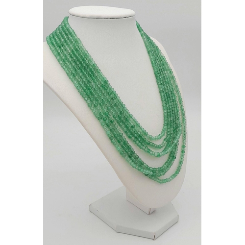 1578 - A seven-row emerald bead necklace. Approx 49cm in length, total weight: 89g