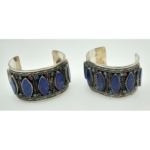 1592 - A Pair of Lapis Lazuli White Metal Cuff Bangles. Approx 6.7cm diameter, 129g total weight.