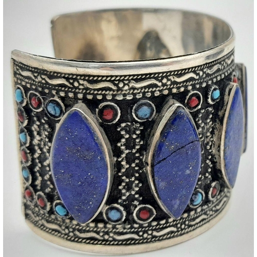 1592 - A Pair of Lapis Lazuli White Metal Cuff Bangles. Approx 6.7cm diameter, 129g total weight.