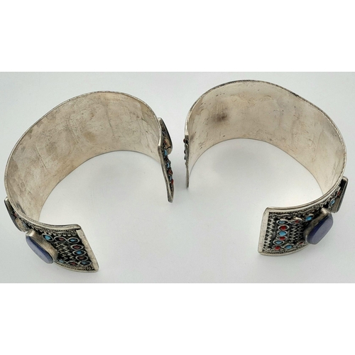 1592 - A Pair of Lapis Lazuli White Metal Cuff Bangles. Approx 6.7cm diameter, 129g total weight.