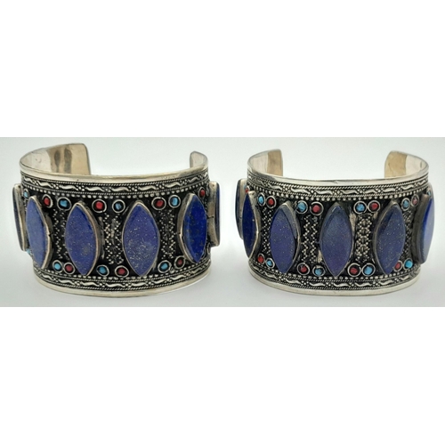 1592 - A Pair of Lapis Lazuli White Metal Cuff Bangles. Approx 6.7cm diameter, 129g total weight.