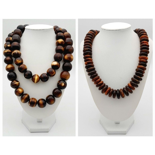 1768 - A pair of African tribal resin necklaces, featuring one with large graduated round beads (apprsox 11... 