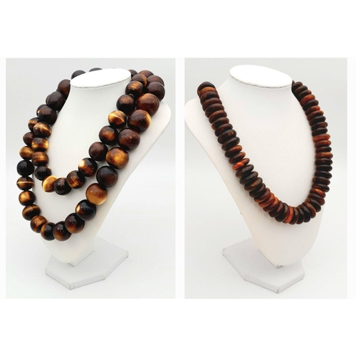 1768 - A pair of African tribal resin necklaces, featuring one with large graduated round beads (apprsox 11... 