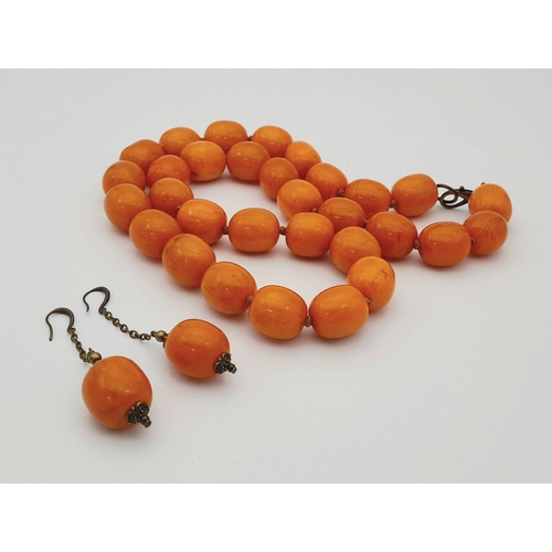 1782 - A matching yellow resin bead necklace and drop earrings suite. The necklace measures approximately 7... 