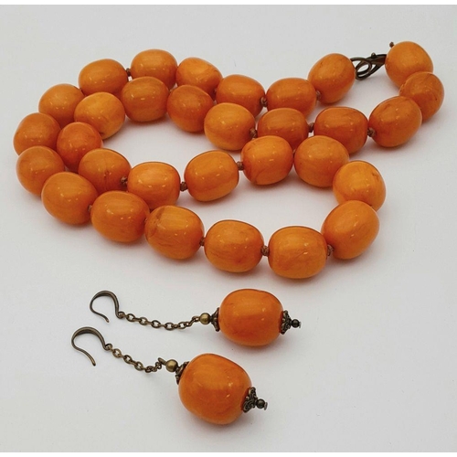 1782 - A matching yellow resin bead necklace and drop earrings suite. The necklace measures approximately 7... 