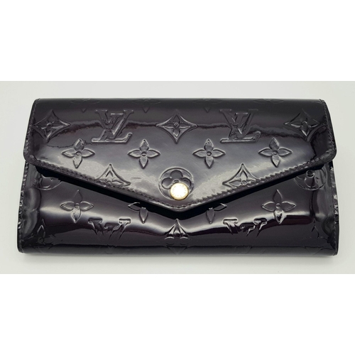 1258 - A Louis Vuitton Patent Leather Purse/Wallet. Monogram exterior. Leather interior with zipped and ope... 