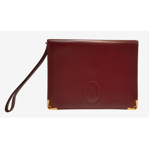 1251 - A Cartier Burgundy Must de Cartier Wallet. Burgundy leather exterior, featuring gold-toned hardware ... 