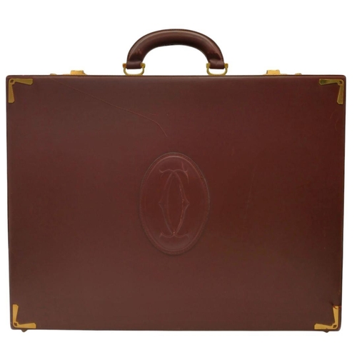 1090 - A Must de Cartier Burgundy Leather Briefcase. Burgundy leather exterior with gold-toned hardware. On... 