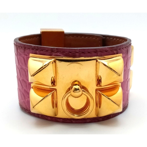 1034 - A Hermes Collier de Chien Leather Bangle/Bracelet. Magenta leather with spike-stud detail. Adjustabl... 