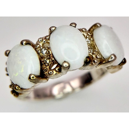 1778 - A Sterling Silver Filigree Design Opal Set Ring Size N. Set with three 8mm Long Opal Cabochons with ... 