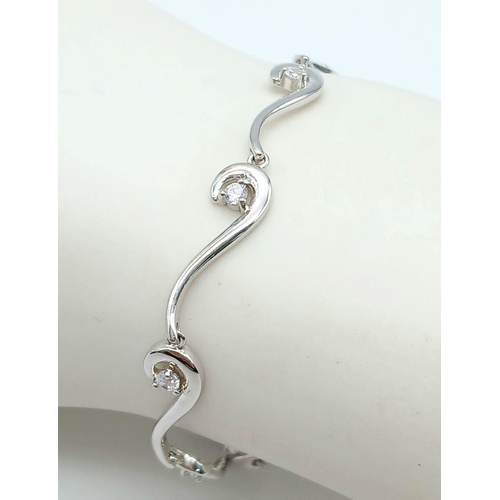 1992 - A 925 Silver Wave Design Cubic Zirconia Tennis Bracelet. 19cm Length. 6mm Width at Widest Point. Gro... 