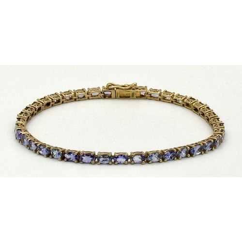 1610 - A Yellow Gold Gilt Sterling Silver Tanzanite Set Tennis Bracelet-21cm Length. Set with Thirty-Nine 5... 