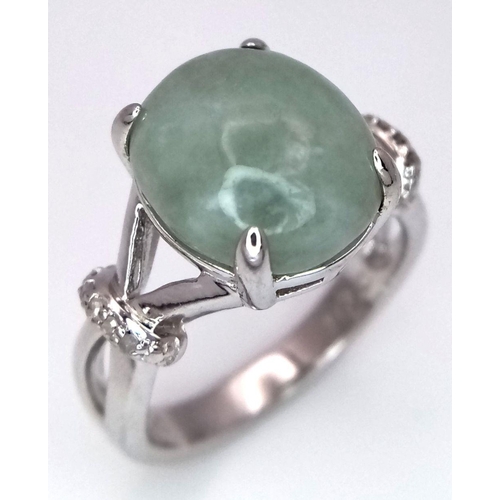 1875 - A Sterling Silver Prehnite Cabochon and Diamond Set Ring Size N. The Ring is set with a 1.2cm Oval C... 