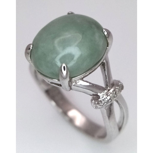 1875 - A Sterling Silver Prehnite Cabochon and Diamond Set Ring Size N. The Ring is set with a 1.2cm Oval C... 