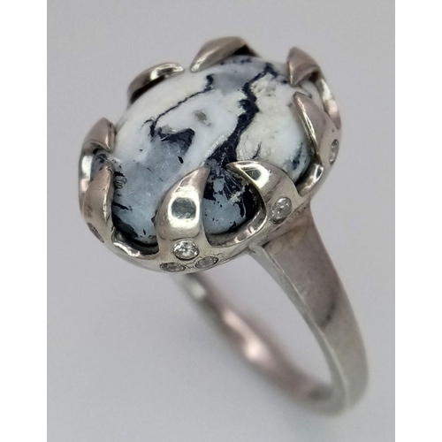 1914 - A Sterling Silver Ring Set with an Oval Cut Dendritic Agate Cabochon in a claw shape mount. The Crow... 