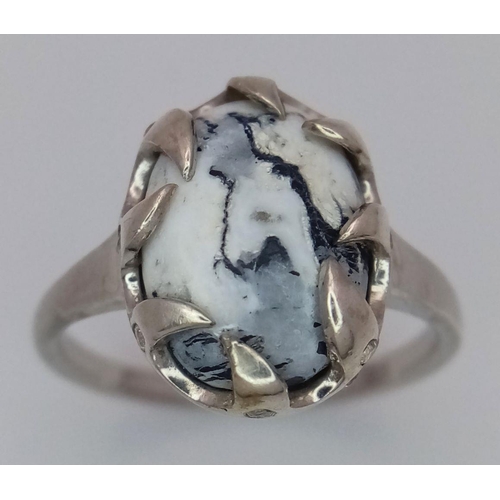 1914 - A Sterling Silver Ring Set with an Oval Cut Dendritic Agate Cabochon in a claw shape mount. The Crow... 