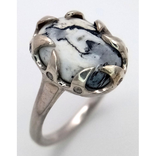 1914 - A Sterling Silver Ring Set with an Oval Cut Dendritic Agate Cabochon in a claw shape mount. The Crow... 