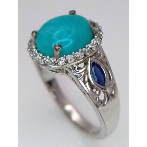 1568 - A Sterling Silver Turquoise Cabochon, Sapphire and White Topaz Set Ring Size S. The Ring is set with... 