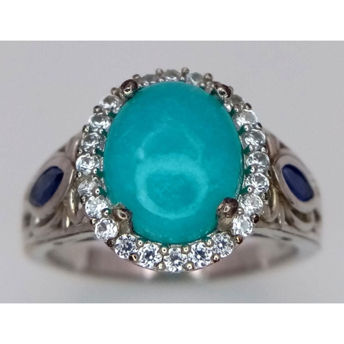 1568 - A Sterling Silver Turquoise Cabochon, Sapphire and White Topaz Set Ring Size S. The Ring is set with... 