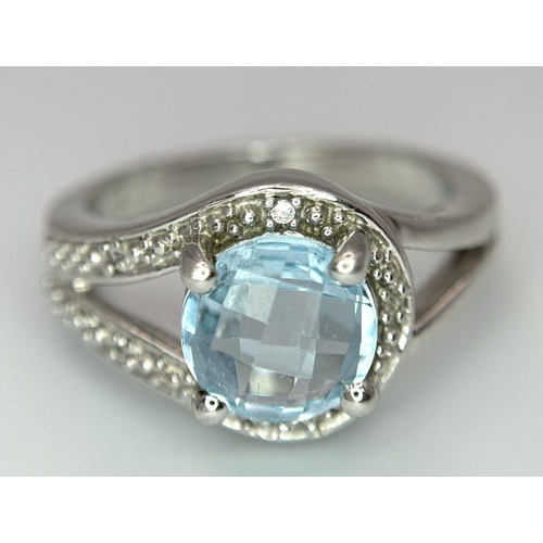 1603 - A Sterling Silver Aquamarine and Diamond Set Ring Size N. Set with an 8mm Round Cut Faceted Aquamari... 