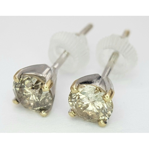 1593 - A Pair of 18K Gold Fancy Brown Diamond Stud Earrings. 1.3ctw. 1.16g total weight. nl12358