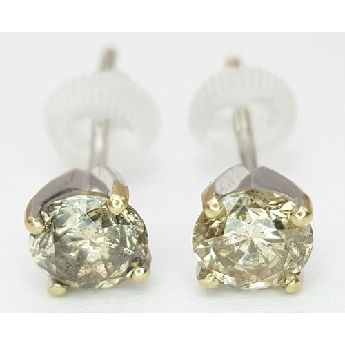 1593 - A Pair of 18K Gold Fancy Brown Diamond Stud Earrings. 1.3ctw. 1.16g total weight. nl12358