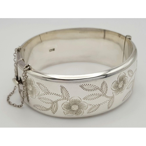 247 - A Vintage Solid Silver 925 Bangle, 42.5 grams, Approx. 6cm diameter, with safety chain. In very good... 