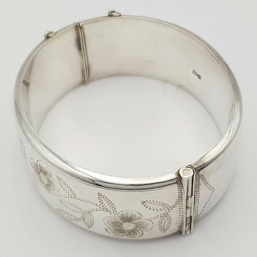 247 - A Vintage Solid Silver 925 Bangle, 42.5 grams, Approx. 6cm diameter, with safety chain. In very good... 