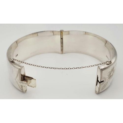 247 - A Vintage Solid Silver 925 Bangle, 42.5 grams, Approx. 6cm diameter, with safety chain. In very good... 