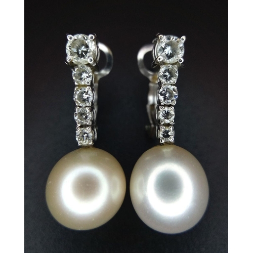 32 - A Pair of 18K White Gold, Diamond and Pearl Earrings. 0.80ctw diamonds. Lever-back clasp. 2cm. 5.05g... 