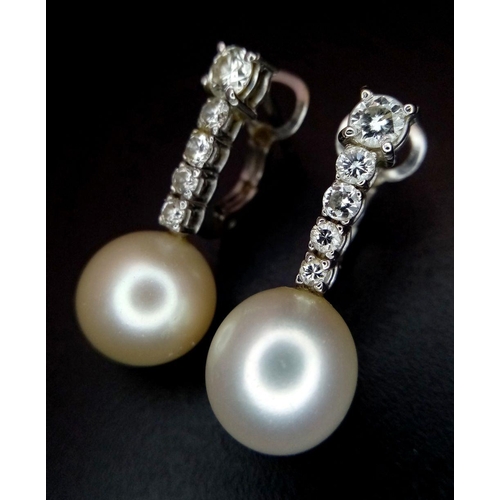 32 - A Pair of 18K White Gold, Diamond and Pearl Earrings. 0.80ctw diamonds. Lever-back clasp. 2cm. 5.05g... 