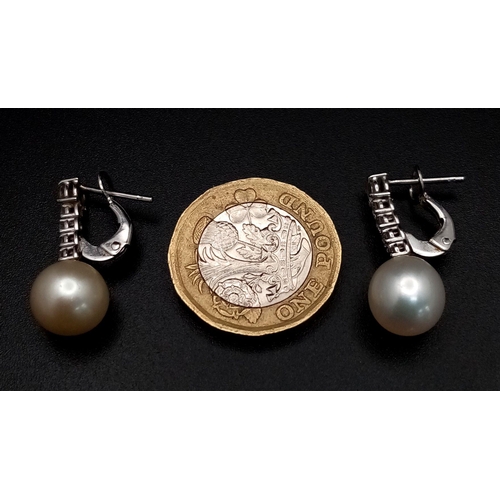 32 - A Pair of 18K White Gold, Diamond and Pearl Earrings. 0.80ctw diamonds. Lever-back clasp. 2cm. 5.05g... 