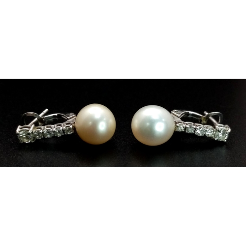 32 - A Pair of 18K White Gold, Diamond and Pearl Earrings. 0.80ctw diamonds. Lever-back clasp. 2cm. 5.05g... 